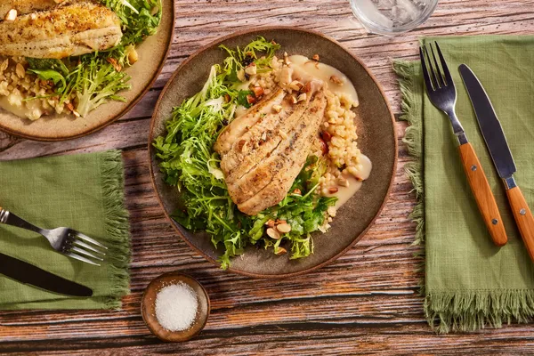 Sole over couscous with citrus beurre blanc and frisee-arugula salad