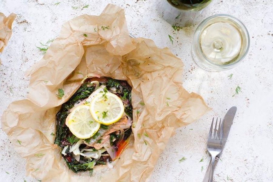 Steamed fish in parchment with chard, baby fennel and lemon dill sauce