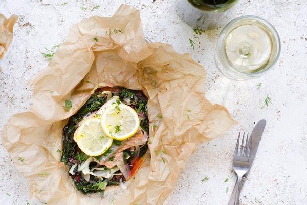 Steamed fish in parchment with chard, baby fennel and lemon dill sauce