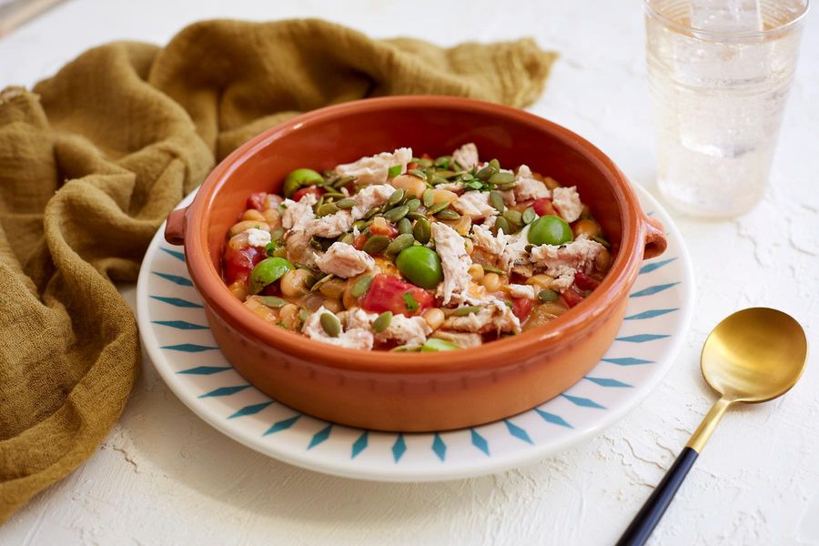 Latin-style chicken stew with green olives and pumpkin seeds