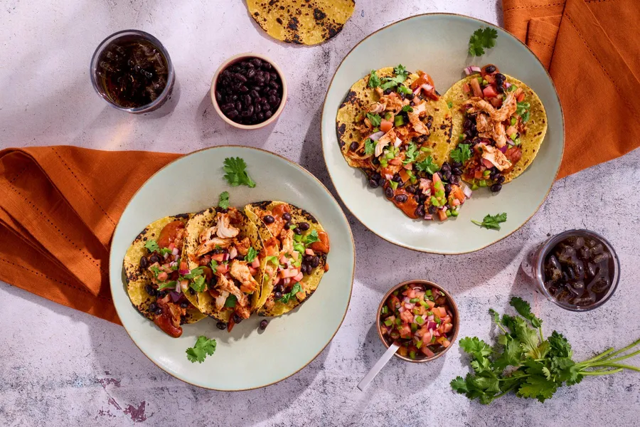 Spicy tinga tacos with black beans and pico de gallo