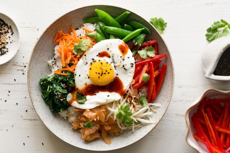 Bibimbap with snap peas, carrots, and fried eggs | Sunbasket