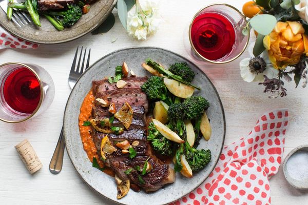 Seared flank steaks with broccolini, roasted parsnips, and romesco