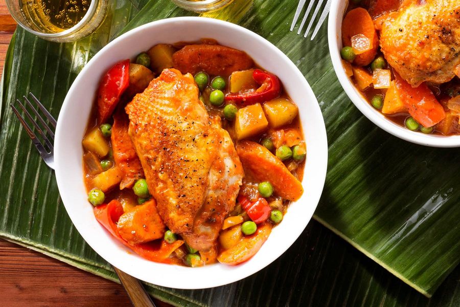 Filipino chicken afritada with potatoes, bell pepper, and peas