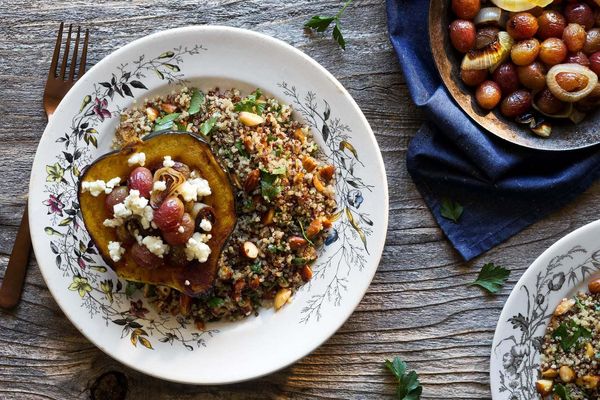 Roasted acorn squash with grapes, goat cheese, and quinoa