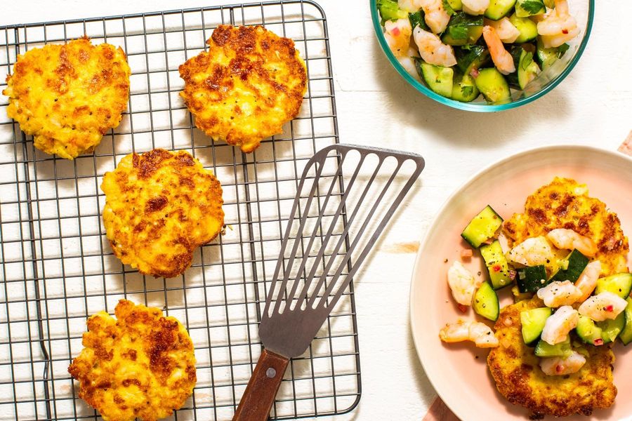 Hominy fritters with shrimp and smashed cucumber salad