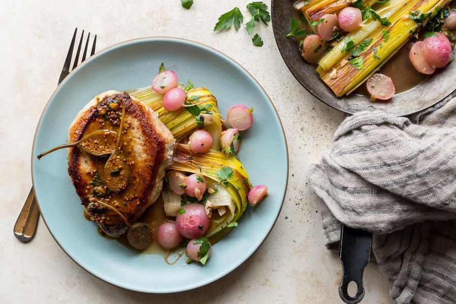 Pork chops with caperberry-mustard sauce and braised leeks