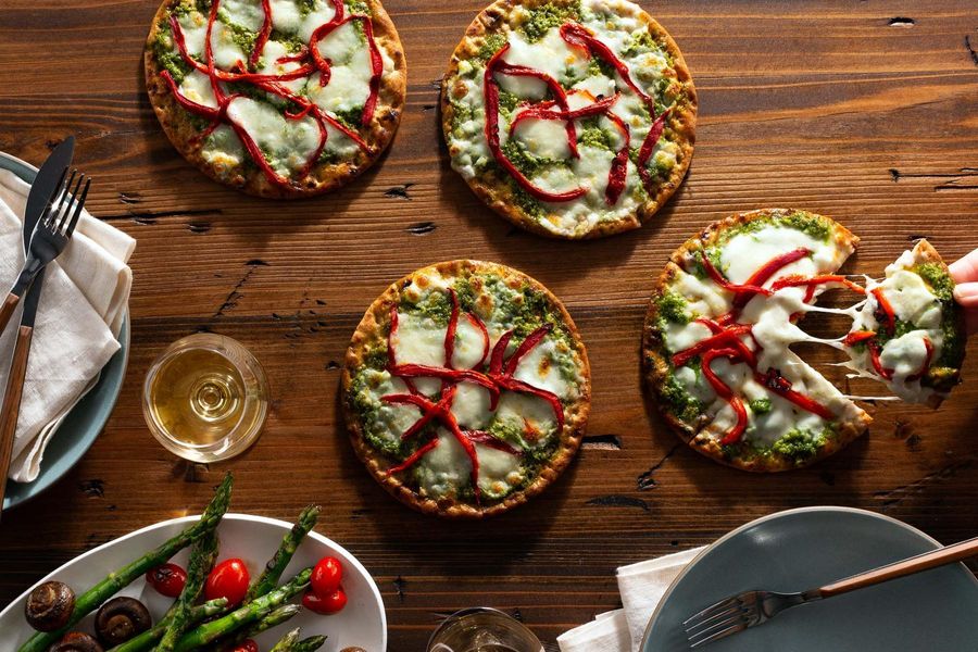 Pesto pizzette with roasted red peppers and fresh mozzarella