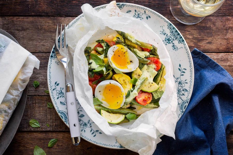 Summer vegetables in parchment with soft-cooked eggs