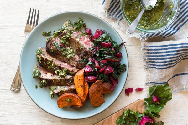Grilled steaks with chimichurri and harissa-roasted sweet potatoes