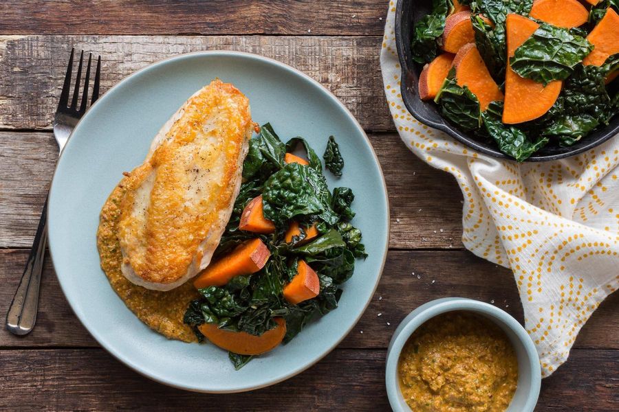 Roast chicken breasts with kale, sweet potatoes, and artichoke romesco