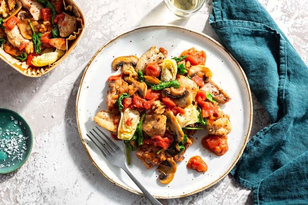 Tomato-braised chicken with mushrooms, artichokes, and walnuts