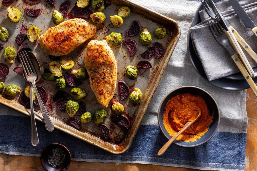 Roasted chicken breasts and fall vegetables with romesco