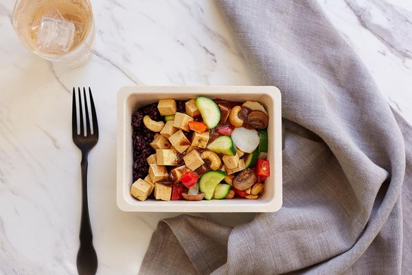 Kung pao tofu bowl with black rice, roasted vegetables, and cashews